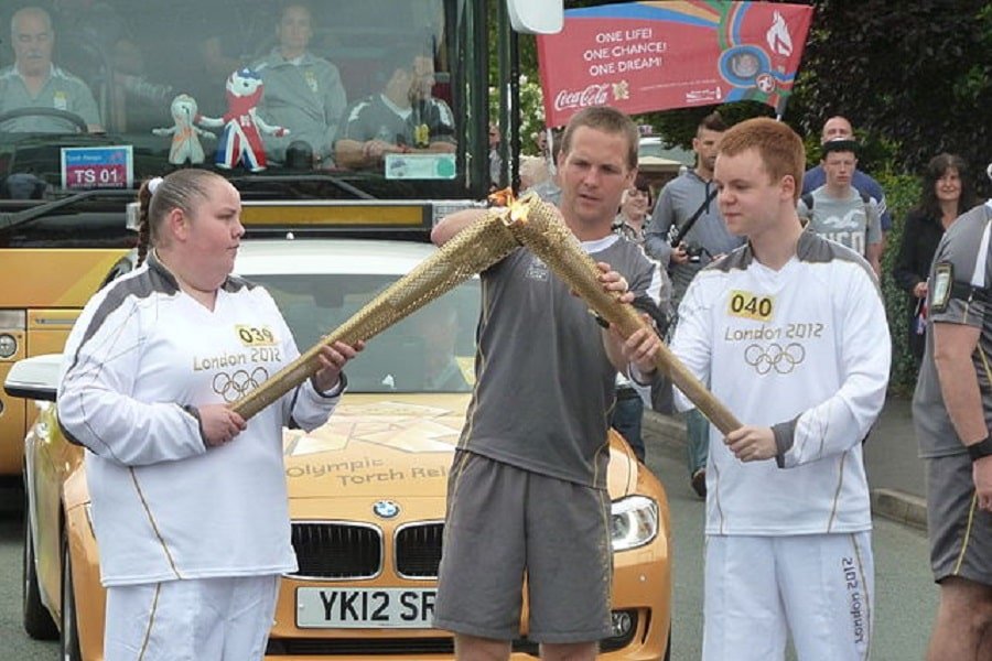 olympic-flame-being-passed-from-one-torch-to-another